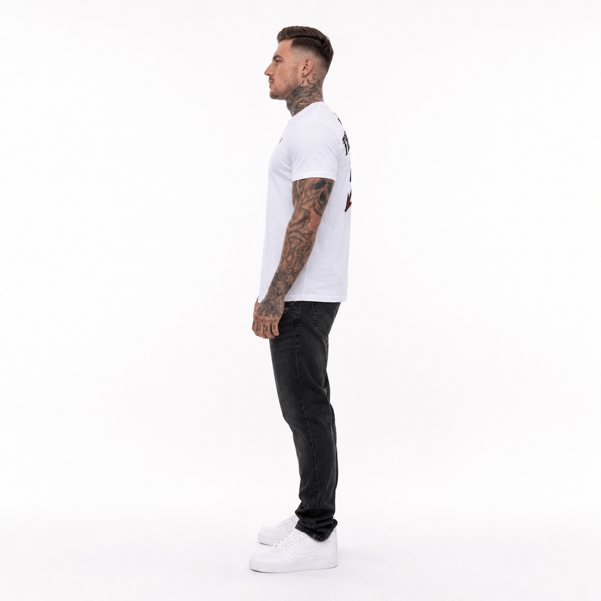 Trust nobody embroidery T-shirt in white worn by model with black jeans, side view