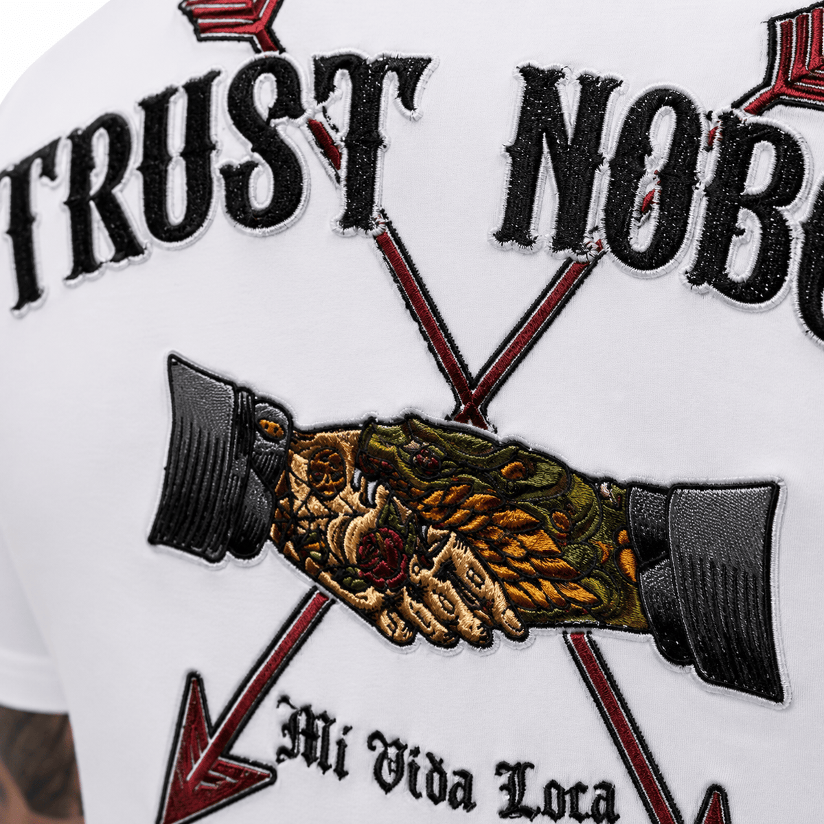 Close-up of the Trust nobody embroidery on the back: handshake between two arrows with Mi Vida Loca lettering