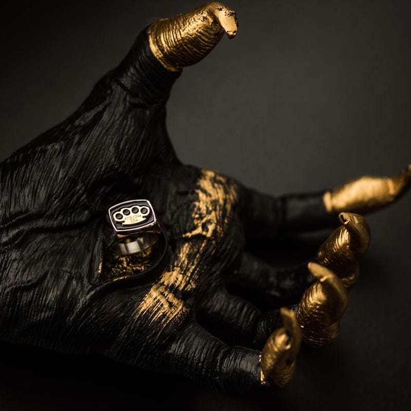 MVL signet ring in silver on a black and gold sculpture hand, lifestyle shot