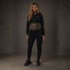 Mi Vida Loca Meander Trainingsanzug-Hoodie für Damen in Schwarz, cropped mit goldenem Band, getragen von Model